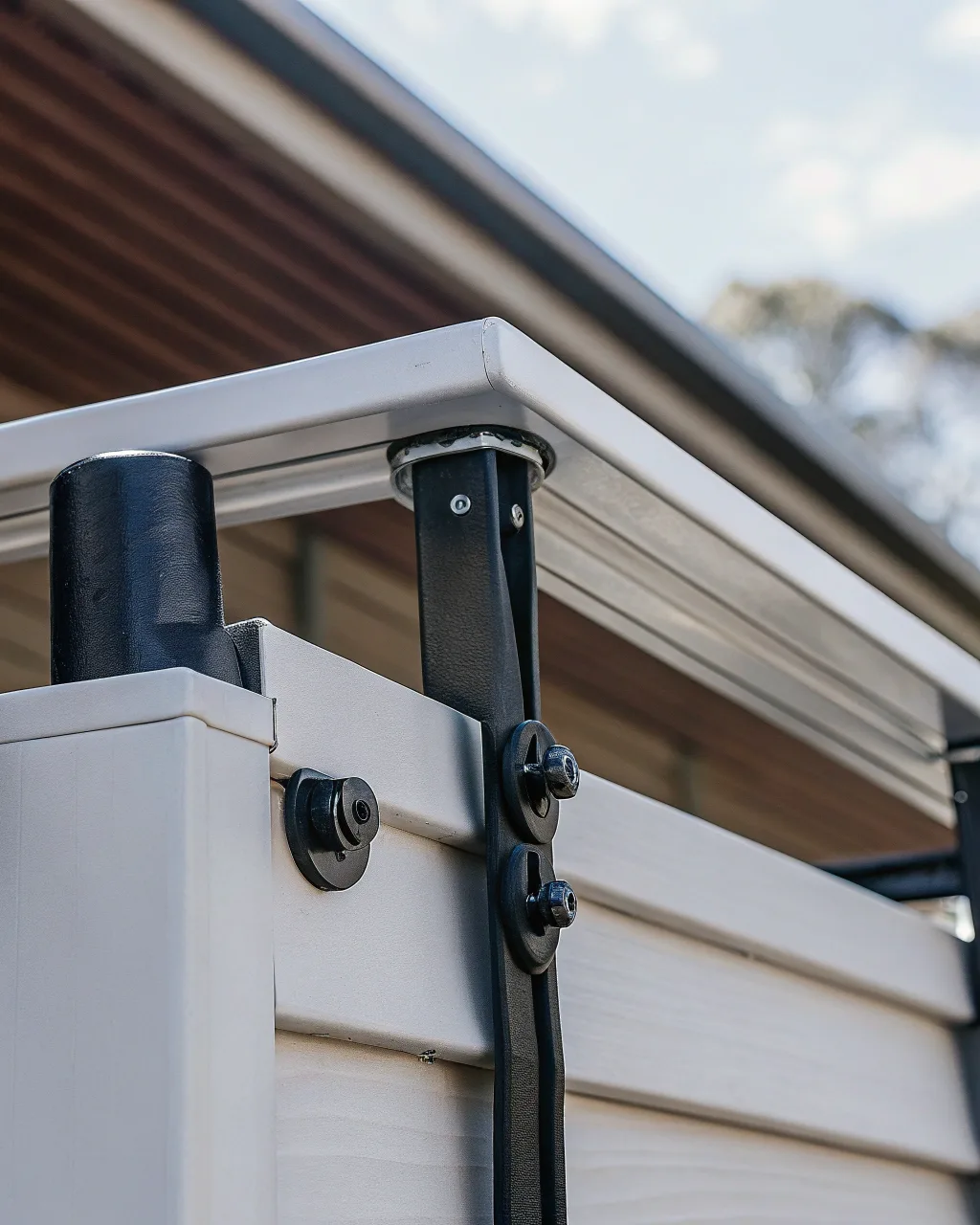 Privacy screen mounting system showing secure metal fixings
