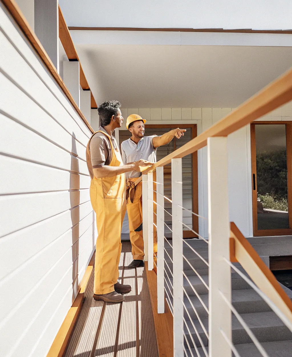 Professional carpenter on a Gold Coast property explaining decking options